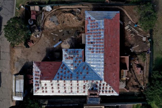 Tiles are stacked strategically around the roof ready for final placement